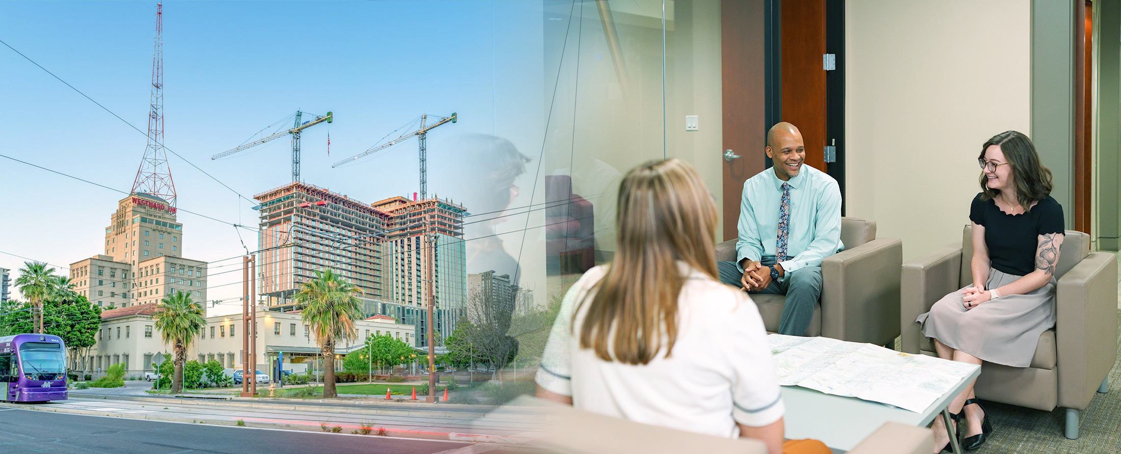 MAG employees collaborating in an office beside a view of downtown Phoenix