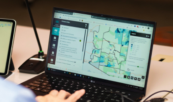 Digital maps and transportation data displayed on computer monitors