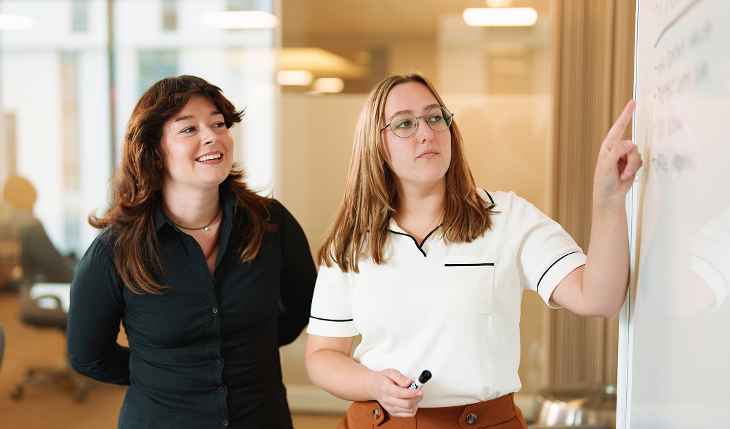 Two MAG colleagues talking in a collaborative workspace