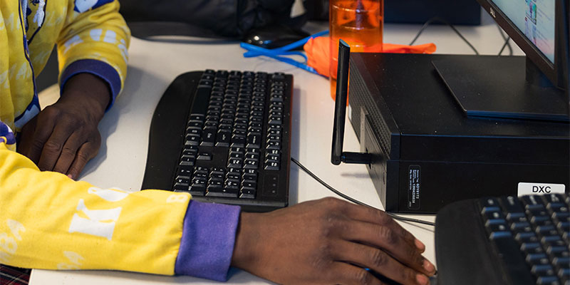 man sitting at a computer desk